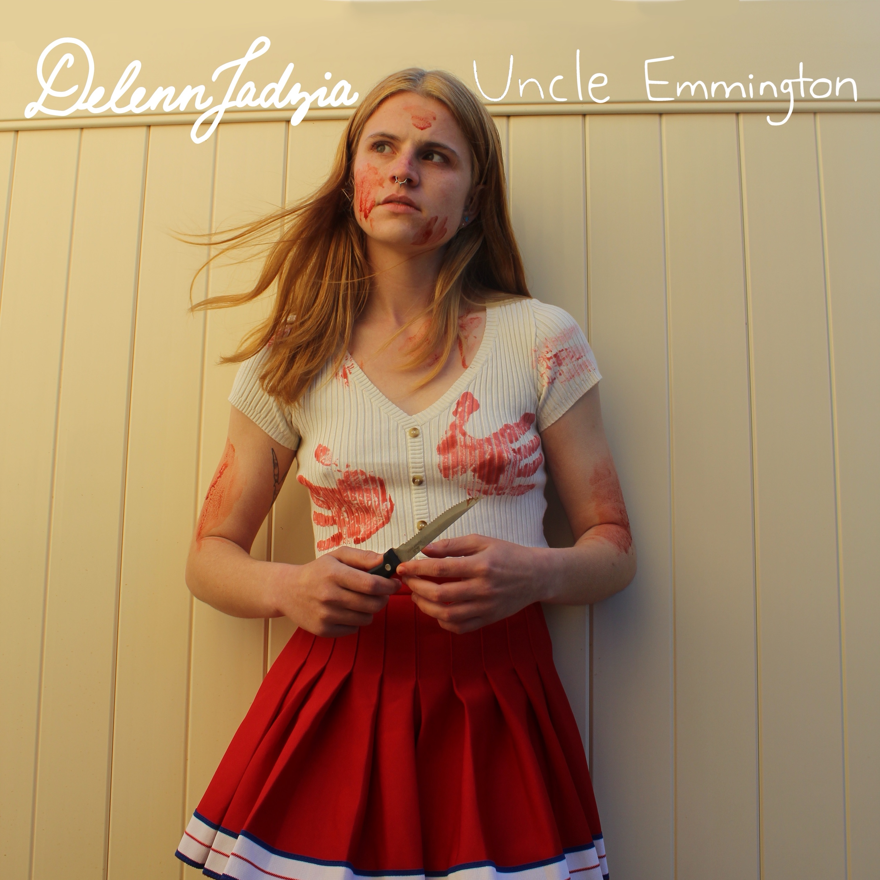 A person in a cheerleading outfit is covered in blood.